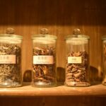 Glass jars filled with dried herbs — photo by Leandro De Torres on Unsplash