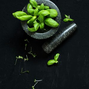 Green basil and wooden mortar — photo by Danielle Suijkerbuijk on Unsplash